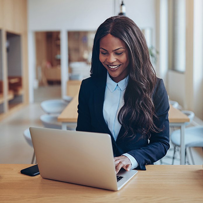 Smiling business woman using her computer