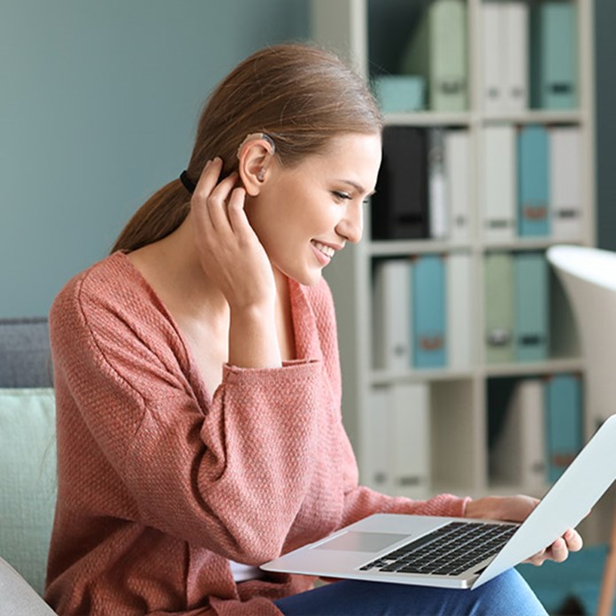 Hearing impaired woman using a laptop