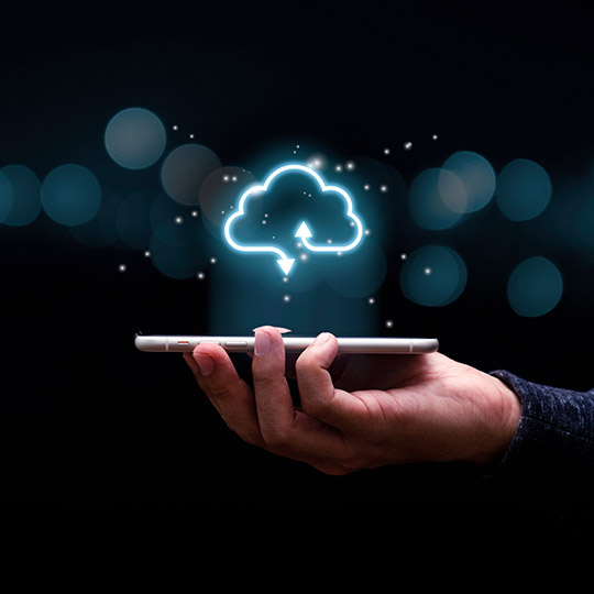 Hand holding cell phone with cloud infrastructure icon hovering above it